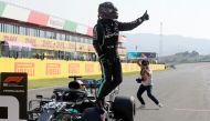 Mercedes' British driver Lewis Hamilton celebrates winning the pole position after the qualifying session at the Mugello circuit ahead of the Tuscany Formula One Grand Prix in Scarperia e San Piero on September 12, 2020. / AFP / POOL / Luca Bruno