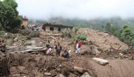 Residents and rescue workers search for bodies of landslides victims, following heavy rains in Bahrabise municipality of Sindhupalchok district, some 90 km northeast of Kathmandu on September 13, 2020. / AFP / NIROJ CHAOULAGAIN