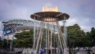 Young Australian athletes Tamsin Colley (L) and Tenayah Logan stand underneath the Sydney 2000 Olympic Games cauldron after it was relit during an event to mark the 20th anniversary of the opening ceremony at Cathy Freeman Park in the Olympic Boulevard in