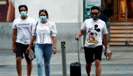 FILE PHOTO: People wearing protective face masks cross the street amid the coronavirus disease (COVID-19) outbreak in Madrid, Spain July 28, 2020. REUTERS/Javier Barbancho/File Photo

