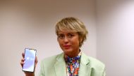 Carme Artigas, head of Spain's state digital and artificial intelligence unit, poses holding a mobile phone with the Radar Covid app before an interview with Reuters in Madrid, September 16, 2020. REUTERS/Sergio Perez