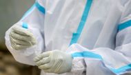 A health worker collects a swab sample from a resident for a Covid-19 coronavirus test at a public health centre in Hyderabad on September 17, 2020. / AFP / NOAH SEELAM