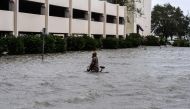 A man walks his bicycle through a street flooded by Hurricane Sally in Pensacola, Florida, on September 16, 2020. Hurricane Sally barrelled into the US Gulf Coast early Wednesday, with forecasts of drenching rains that could provoke 