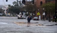 A man stands on a street flooded by Hurricane Sally in Pensacola, Florida, on September 16, 2020. Hurricane Sally barrelled into the US Gulf Coast early Wednesday, with forecasts of drenching rains that could provoke 