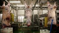 FILE PHOTO: A worker removes entrails from beef carcasses at Meat Plant Biernacki slaughterhouse in Golina near Jarocin western Poland July 17, 2013. REUTERS/Kacper Pempel