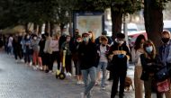 FILE PHOTO: People wait in a line to get tested for the coronavirus disease (COVID-19) before a sampling station opens at Wenceslas Square in PRAGUE, Czech Republic, September 16, 2020. REUTERS/David W Cerny/File Photo
