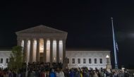 The national flag flies at half staff as people gather to mourn the passing of Supreme Court Justice Ruth Bader Ginsburg at the steps in front of the Supreme Court on September 18, 2020 in Washington, DC. Tasos Katopodis/Getty Images/AFP
