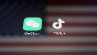 A reflection of the US flag is seen on the signs of the WeChat and TikTok apps in this illustration picture taken on September 19, 2020. REUTERS/Florence Lo/Illustration