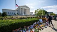 People place flowers outside of the US Supreme Court in memory of Justice Ruth Bader Ginsburg, in Washington, DC, on September 19, 2020.   AFP / Jose Luis Magana