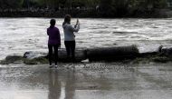 People take pictures of the Gardon river following floods in Anduze, southeastern France on September 19, 2020. AFP / NICOLAS TUCAT