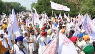 Farmers shout slogans as they march to burn an effigy of India's Prime Minister Narendra Modi and Union Agriculture Minister Narendra Singh Tomar, following the passing of agriculture bills in the Lok Sabha (lower house) of representatives, on the outskir