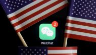 FILE PHOTO: The messenger app WeChat is seen among U.S. flags in this illustration picture taken Aug. 7, 2020. Reuters/Florence Lo/Illustration/File Photo