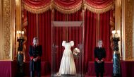 Two Windsor Castle wardens view the wedding dress worn by Princess Beatrice of York at her July 2020 wedding, which was originally worn by Britain's Queen Elizabeth in the 1960s, ahead of it going on public display at Windsor Castle, Windsor, Britain, Sep