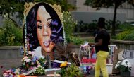 FILE PHOTO: A woman visits the memorial for Breonna Taylor in Louisville, Kentucky, U.S., September 11, 2020. REUTERS/Bryan Woolston/File Photo/File Photo
