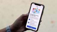 The coronavirus disease (COVID-19) contact tracing smartphone app of Britain's National Health Service (NHS) is displayed on an iPhone in this illustration photograph taken in Keele, Britain, September 24, 2020. REUTERS/Carl Recine/Illustration