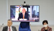 President of the Tokyo 2020 Organising Committee Yoshiro Mori (L) and Tokyo governor Yuriko Koike (R) listen as International Olympic Committee (IOC) president Thomas Bach (on screen) speaks during a video meeting of the IOC Coordination Commission for th