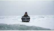 Environmental activist and campaigner Mya-Rose Craig, 18, holds a cardboard sign reading 