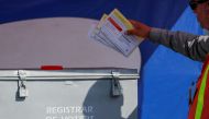 FILE PHOTO: An election worker places mail-in ballots into an election box at a drive-through drop off location at the Registrar of Voters in San Diego, California, U.S. November 5, 2018. REUTERS/Mike Blake/File Photo
