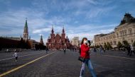 A woman wearing a face mask to protect against the coronavirus disease walks on Red Square in downtown Moscow on September 24, 2020. / AFP / Yuri KADOBNOV
