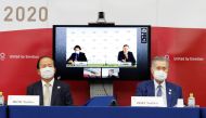 Christophe Dubi, IOC's Olympic Games Executive Director, and Robert Roxburgh, Head of Olympic Games Communications of IOC, are seen on screen during a joint press conference between the International Olympic Committee (IOC) and Tokyo Organising Committee 