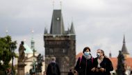 People wearing face masks walk across the medieval Charles Bridge as the spread of the coronavirus disease (COVID-19) continues in Prague, Czech Republic, September 25, 2020. REUTERS/David W Cerny