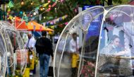 A woman sits outside Cafe Du Soleil under bubble tents following the outbreak of the coronavirus disease (COVID-19) in the Manhattan borough of New York City, New York, U.S., September 23, 2020. REUTERS/Jeenah Moon/File Photo