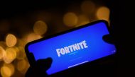 In this file photo taken on August 14, 2020 This illustration picture shows a person logging into Epic Games' Fortnite on their smartphone in Los Angeles. Epic Games will strive anew September 28 to convince a judge that its hit title Fortnite should be r