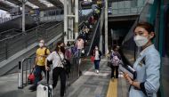 Travellers arrive to board a train as South Korea prepares to mark the annual Chuseok festival holiday, at Seoul station on September 29, 2020. / AFP / Ed JONES