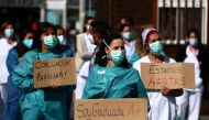 Nurses hold placards during a protest demanding better working conditions outside La Paz hospital amid the outbreak of the coronavirus disease (COVID-19), in Madrid, Spain September 28, 2020. REUTERS/Sergio Perez

