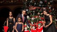 U.S. President Barack Obama, first lady Michelle Obama and their daughters Malia (L), Sasha (2nd L) greet children dressed as elves at the Christmas in Washington Celebration at the National Building Museum in Washington, DC, U.S. December 12, 2010. REUTE