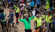 Cyprine Odada (C), organiser for the Nairobi chapter of Critical Mass, a global alliance of cycling organisations that campaigns for better road safety, gestures among cyclists as they commemorate a friend who was killed while cycling in Nairobi, Kenya Se