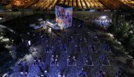 People are seen seated in outlined sections, created to promote social distancing as an attempt to fight the spread of the coronavirus disease (COVID-19), while viewing a screening as part of Movie Nights with Tribeca Film Festival at the Backyard At Huds