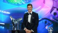 This handout picture taken and released by UEFA on October 1, 2020, shows Bayern Munich's Polish forward Robert Lewandowski poses after receiving the season 2019/2020 player of the year award during the UEFA Champions League group stage draw at the RTS st