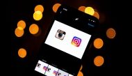 This picture taken on September 28, 2020 shows the logo of the social network Instagram on a smartphone, in Toulouse, southwestern France. The Instagram group will, in early October 2020, celebrate its ten-year anniversary. / AFP / Lionel BONAVENTURE
