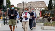 People wear face masks as local authorities in the Italian capital ROME order face coverings to be worn at all times out of doors in an effort to counter rising coronavirus disease (COVID-19) infections, in ROME, Italy October 2, 2020. REUTERS/Guglielmo M