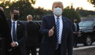 TOPSHOT - US President Donald Trump gestures after walking out of Walter Reed Medical Center in Bethesda, Maryland before heading to Marine One on October 5, 2020, to return to the White House after being discharged. Trump announced he would be 