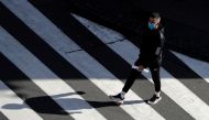A man wearing a face mask walks on a crosswalk as the spread of the coronavirus disease (COVID-19) continues in Prague, Czech Republic, October 1, 2020. REUTERS/David W Cerny
