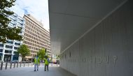 Two workers are seen on empty pavement next to the World Bank headquarters at lunchtime in Washington, DC on October 1, 2020.  AFP / Eric BARADAT
