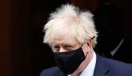 Britain's Prime Minister Boris Johnson (R), wearing a face-covering due to the Covid-19 pandemic, leaves 10 Downing Street in central London on October 7, 2020, to attend the weekly session of Prime Minister's Questions (PMQs) at the House Commons. AFP / 