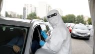 FILE PHOTO: People are tested for the coronavirus disease (COVID-19) at a drive-thru testing centre in Warsaw, Poland, October 2, 2020. REUTERS/Kacper Pempel/File Photo