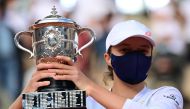 Poland's Iga Swiatek celebrates with the Suzanne Lenglen trophy during the podium ceremony after winning the women's singles final tennis match against Sofia Kenin of the US, at the Philippe Chatrier court, on Day 14 of The Roland Garros 2020 French Open 