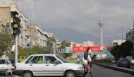 An Iranian woman wearing a face mask crosses a street after Iranian authorities made it mandatory for all to wear face masks in public following the outbreak of the coronavirus disease (COVID19), in Tehran Iran October 10, 2020. Majid Asgaripour/WANA  
