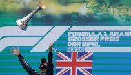 Winner Mercedes' British driver Lewis Hamilton celebrates with his trophy on the podium after the German Formula One Eifel Grand Prix at the Nuerburgring circuit in Nuerburg, western Germany, on October 11, 2020. (AFP / POOL / RONALD WITTEK)