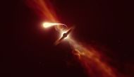 This handout picture released by The European southern Observatory on October 12, 2020, shows an illustration depicting a star (in the foreground) experiencing spaghettification as it’s sucked in by a supermassive black hole (in the background) during a 