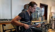 Radiohead guitarist Ed O'Brien plays a Circle Guitar, a radical redesign of the instrument that strums itself, in a studio in London, Britain, October 1, 2020. Picture taken October 1, 2020. REUTERS/Stuart McDill