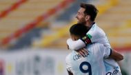 Argentina's Joaquin Correa celebrates with teammate Lionel Messi (top) after scoring against Bolivia during their 2022 FIFA World Cup South American qualifier football match at the Hernando Siles Stadium in La Paz on October 13, 2020, amid the COVID-19 no