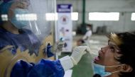 A vendor at Pritil Public Market gets a free swab test amid the coronavirus disease (COVID-19) outbreak, in Tondo, Manila, Philippines, October 8, 2020. REUTERS/Eloisa Lopez
