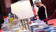 An employe of the Frankfurt Book fair works on book shelves prior the opening press conference of the 2020 Frankfurt Book fair on October 13, 2020.  AFP / POOL / Arne Dedert