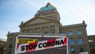 FILE PHOTO: A sign is pictured in front of the Swiss Parliament Building (Bundeshaus) during a federal council meeting on the outbreak of the coronavirus disease (COVID-19) in Bern, Switzerland, April 16, 2020. REUTERS/Denis Balibouse

