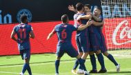 Atletico Madrid's Uruguayan forward Luis Suarez (C) celebrates with teammates after scoring a goal during the Spanish League football match between Celta Vigo and Atletico Madrid at the Balaidos stadium in Vigo on October 17, 2020. / AFP / MIGUEL RIOPA
